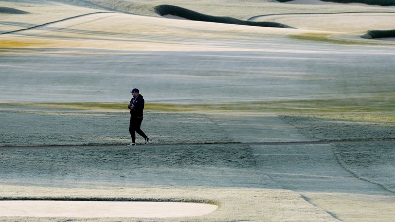 A worker walks the course during during a frost delay before the first round of the PGA Championship golf tournament at Oak Hill Country Club on Thursday, May 18, 2023, in Pittsford, N.Y. (AP Photo/Seth Wenig)