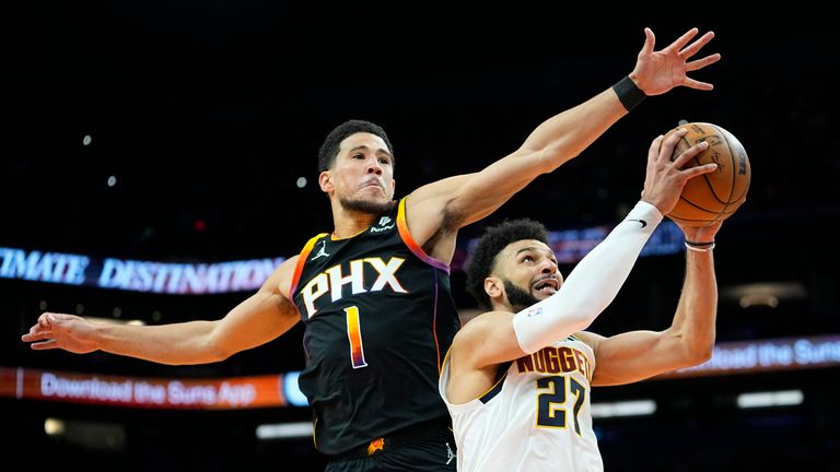 Phoenix Suns guard Devin Booker blocks the shot of Denver Nuggets guard Jamal Murray