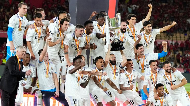 Real Madrid team players and head coach Carlo Ancelotti celebrate with the trophy after Madrid defeated Osasuna 2-1 in the Copa del Rey soccer final at La Cartuja stadium in Seville, Spain, Saturday, May 6, 2023. (AP Photo/Jose Breton)