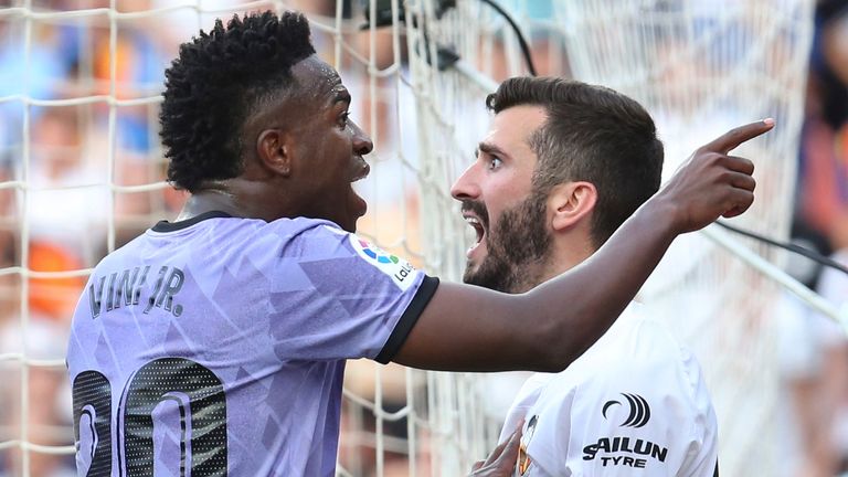 Real Madrid's Vinicius Junior, left, confronts Valencia fans in front of Valencia's Jose Luis Gaya 