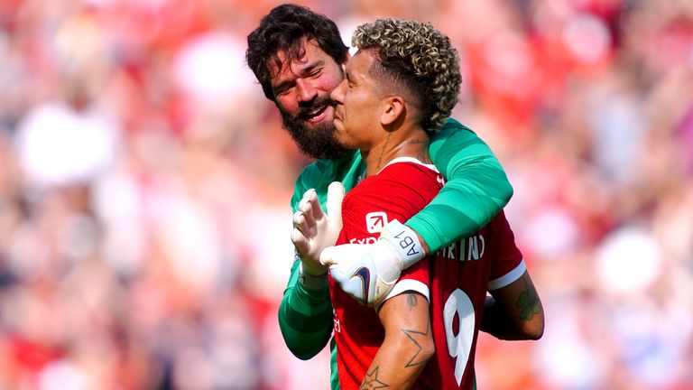 Roberto Firmino is embraced by team-mate Alisson at full time