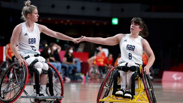 Britain's Robyn Love (L) and her partner Laurie Williams touch hands during the Tokyo 2020 Paralympic Games 