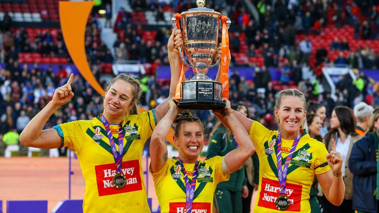 MANCHESTER, ENGLAND - NOVEMBER 19: The Australia women...s team lift the trophy during Women's Rugby League World Cup Final match between Australia and New Zealand at Old Trafford on November 19, 2022 in Manchester, England. (Photo by Alex Dodd - CameraSport via Getty Images)