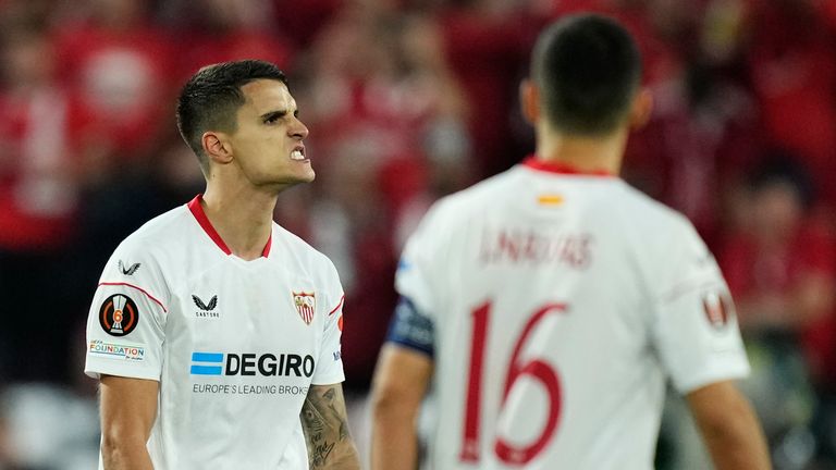 Sevilla's Erik Lamela, left, celebrates after scoring