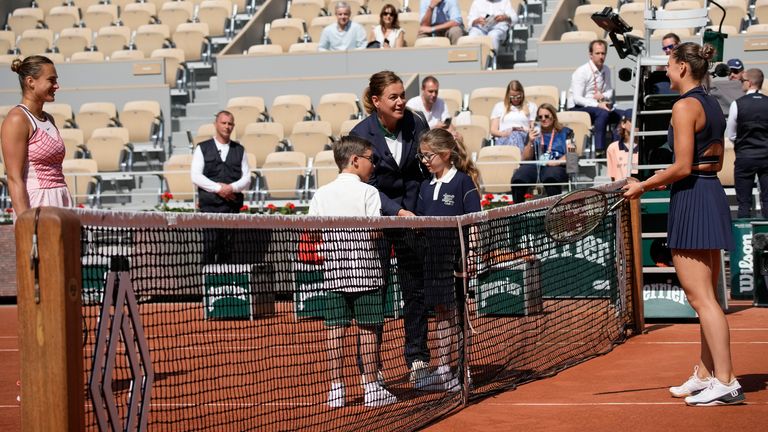 Aryna Sabalenka of Belarus, left, and Ukraine's Marta Kostyuk, refused to pose for the traditional pre-match picture with the ball children in their first round match of the French Open (Associated Press)
