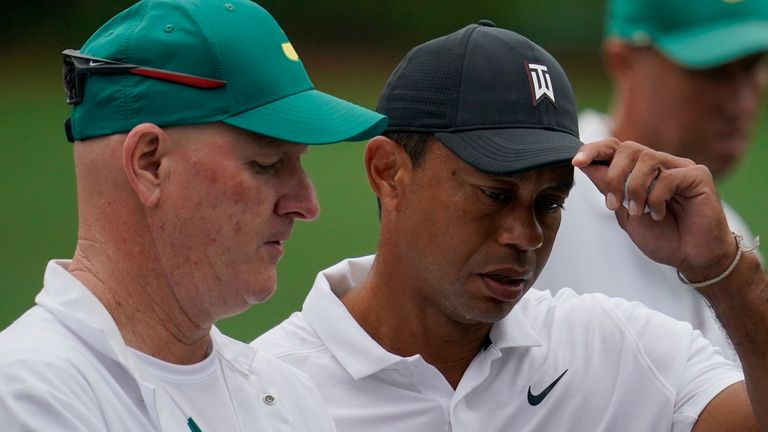 Tiger Woods speaks with his caddie Joe LaCava on the 12th hole during a practice round for the Masters golf tournament on Wednesday, April 6, 2022, in Augusta, Ga. (AP Photo/Robert F. Bukaty) 