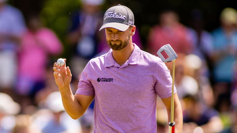 Wyndham Clark waves after his birdie putt on the 8th green during the third round of the 2023 Wells Fargo Championship at Quail Hollow