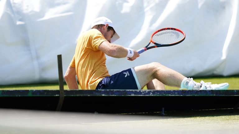 Andy Murray crashes through a billboard during the men's singles 32nd round match on center court against South Korea's Chung Hyeon on day one of the 2023 Lexus Surbiton Trophy at Surbiton Racket and Fitness Club, London .  Picture date: Monday June 5, 2023.