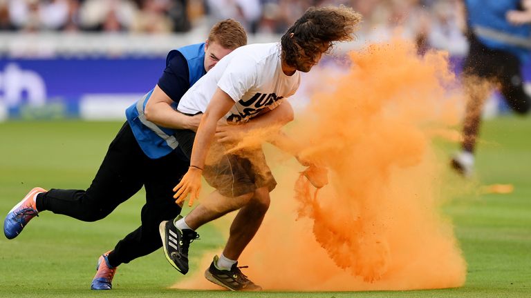 A security guard tackles a Just Stop Oil protestor at Lord&#39;s