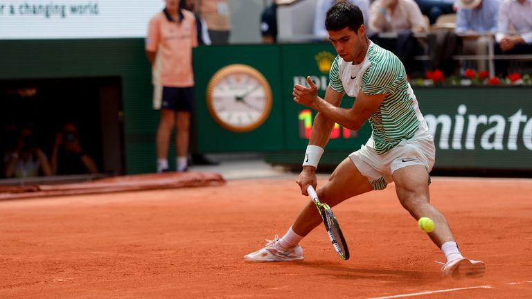 Spain's Carlos Alcaraz plays a shot and score with his back to Serbia's Novak Djokovic in the third game of the second set of their semifinal match of the French Open tennis tournament of the French Open tennis tournament at the Roland Garros stadium in Paris, Friday, June 9, 2023. (AP Photo/Jean-Francois Badias)