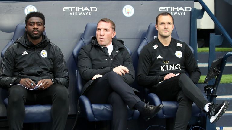 Kolo Toure and Chris Davies flank Brendan Rodgers on the Leicester City bench