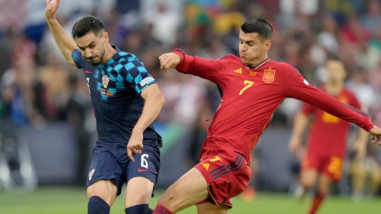Croatia's Josip Sutalo vies for the ball with Spain's Alvaro Morata