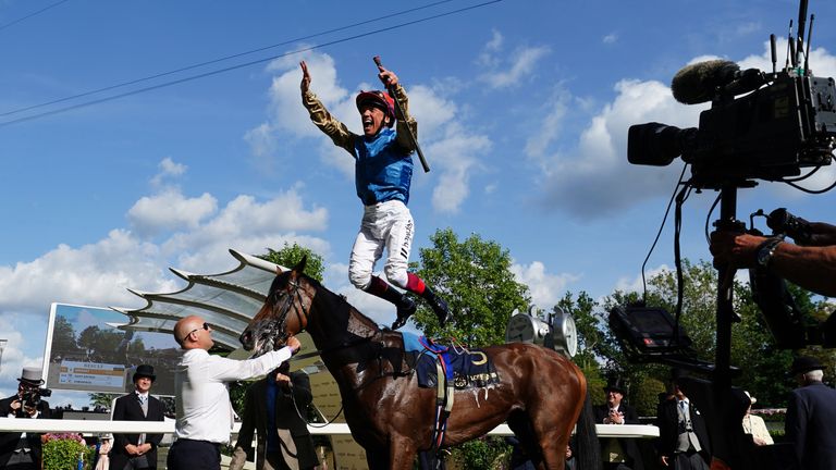 Frankie Dettori performs his famous flying dismount celebration after Gregory's success in the Queen's Vase