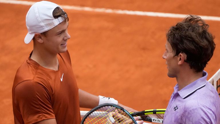 Denmark&#39;s Holger Rune, left, shakes hand with Norway&#39;s Casper Ruud after winning a semi final match at the Italian Open tennis tournament in Rome, Italy, Saturday, May 20, 2023. (AP Photo/Gregorio Borgia)