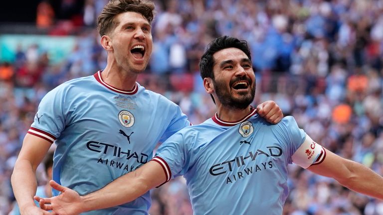 Manchester City's Ilkay Gundogan celebrates after scoring his side's second goal with John Stones