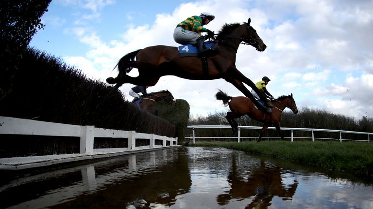 Joly Maker (yellow and green) clears a fence at Leicester