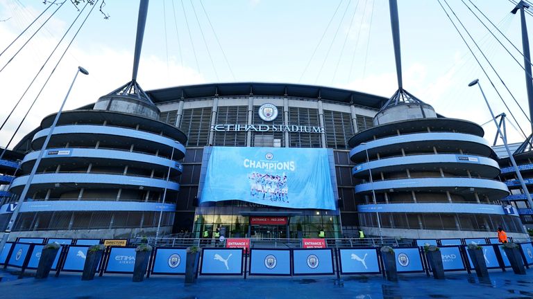 A banner is unfurled outside the Etihad Stadium in Manchester, England, Tuesday, May 11, 2021 after the Manchester City team clinched the English Premier League title. City took the title after crosstown rivals Manchester United lost at home to Leicester City. (AP Photo/Jon Super)