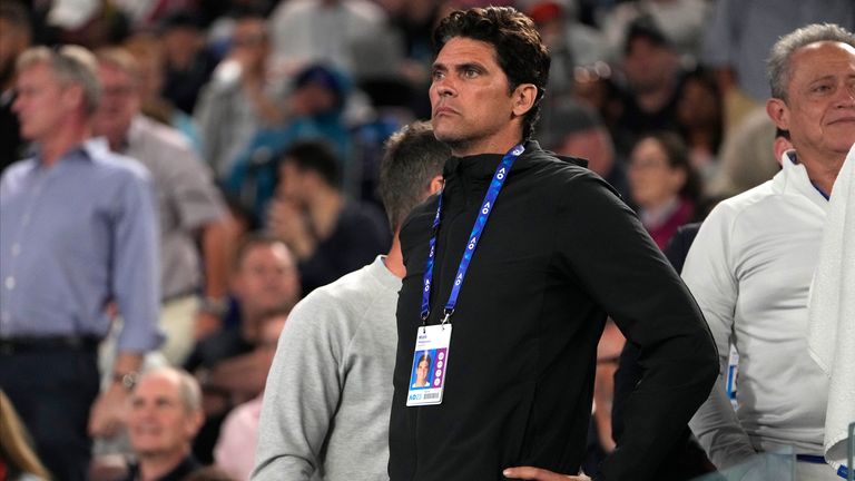 Mark Philippoussis, member of the coaching team for Stefanos Tsitsipas of Greece, watches the fourth round match between Tsitsipas and Jannik Sinner of Italy at the Australian Open tennis championship in Melbourne, Australia, Sunday, Jan. 22, 2023. (AP Photo/Mark Baker)
