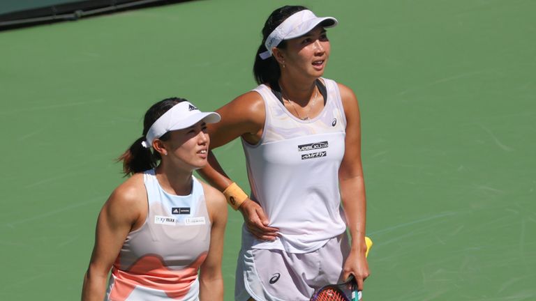 Miyu Kato (JPN) and Aldila Sutjiadi (INA) look across the court to their doubles opponents during the BNP Paribas Open on March 17, 2023 at the Indian Wells Tennis Garden in Indian Wells, CA. (Photo by George Walker/Icon Sportswire via Getty Images)