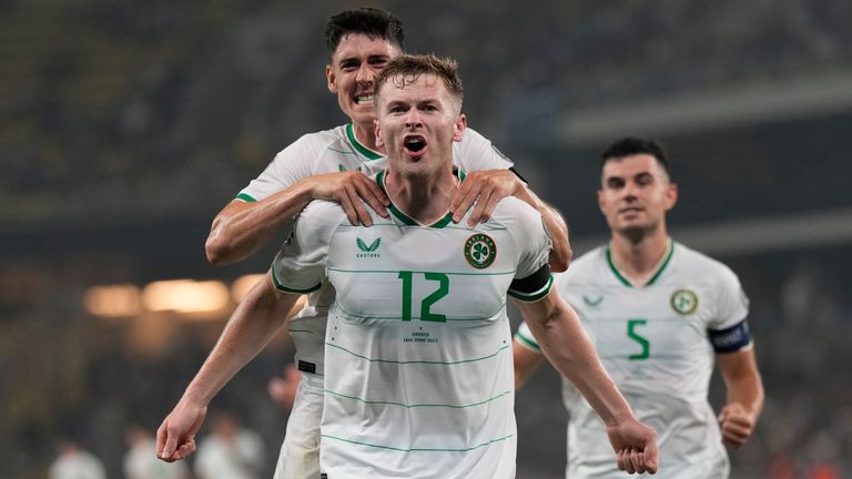 Ireland's Nathan Collins, center, celebrates after scoring his side's opening goal during the Euro 2024 group B qualifying soccer match between Greece and Ireland at the OPAP Arena in Athens, Greece, Friday, June 16, 2023. (AP Photo/Petros Giannakouris)