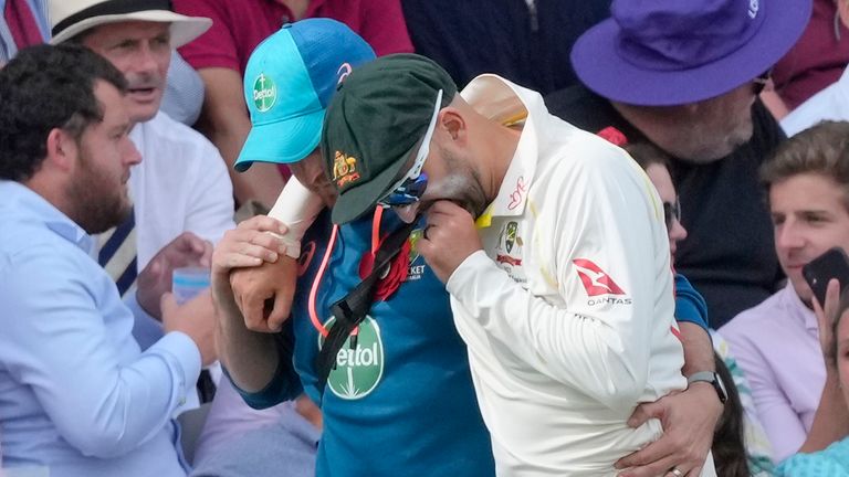 Australia&#39;s Nathan Lyon is helped off the pitch after an injury during the second day of the second Ashes Test cricket match at Lord&#39;s.