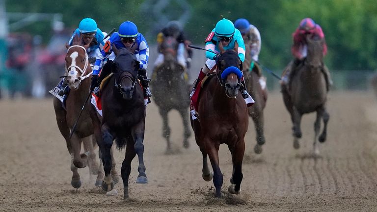 John Velazquez, right, atop National Treasure win the Preakness at Pimlico