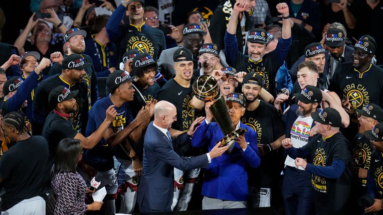 Denver Nuggets players, coaches and owners pose with the Larry O'Brien NBA Championship Trophy after their victory over the Miami Heat in Game Five of the NBA Finals