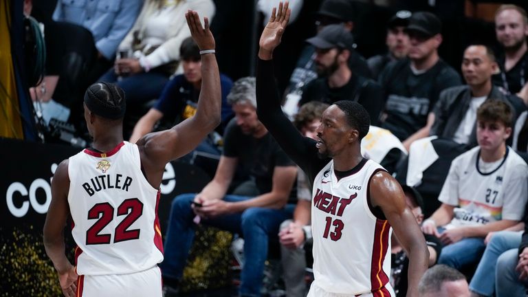 Miami Heat center Bam Adebayo, right, celebrates with forward Jimmy Butler.
