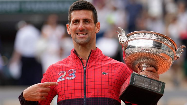 Serbia's Novak Djokovic points at 23 on his garment as he celebrates winning the men's singles final match of the French Open tennis tournament against Norway's Casper Ruud in three sets, 7-6, (7-1), 6-3, 7-5, at the Roland Garros stadium in Paris, Sunday, June 11, 2023. Djokovic won his record 23rd Grand Slam singles title, breaking a tie with Rafael Nadal for the most by a man. (AP Photo/Thibault Camus)