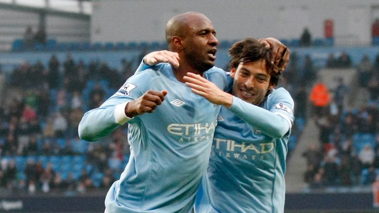 Manchester City's Patrick Vieira, left, celebrates scoring against Notts County with teammate David Silva during their English FA Cup fourth round replay soccer match at the City of Manchester Stadium, Manchester, England, Sunday Feb. 20, 2011.