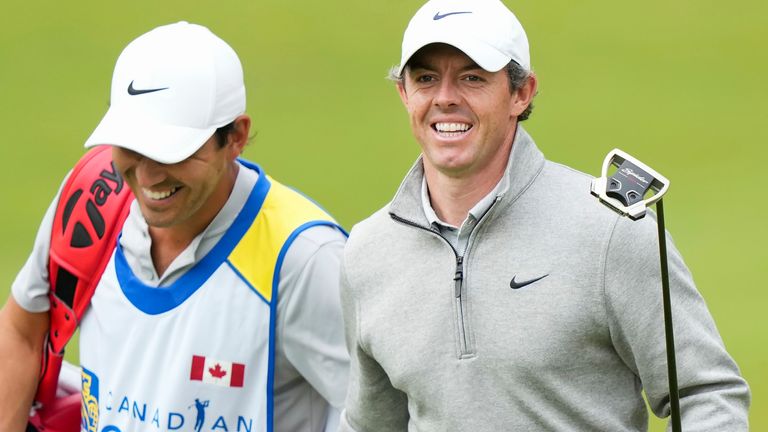 Rory McIlroy, right, of Northern Ireland, laughs with his caddie on the eighth hole during second round at the Canadian Open golf championship in Toronto, Friday, June 9, 2023. (Nathan Denette/The Canadian Press via AP)