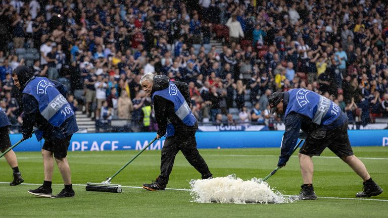 GLASGOW, SCOTLAND - JUNE 20: Pitch staff try to clear the water off the park during a UEFA Euro 2024 qualifier between Scotland and Georgia at Hampden Park, on June 20, 2023, in Glasgow, Scotland. (Photo by Alan Harvey / SNS Group)