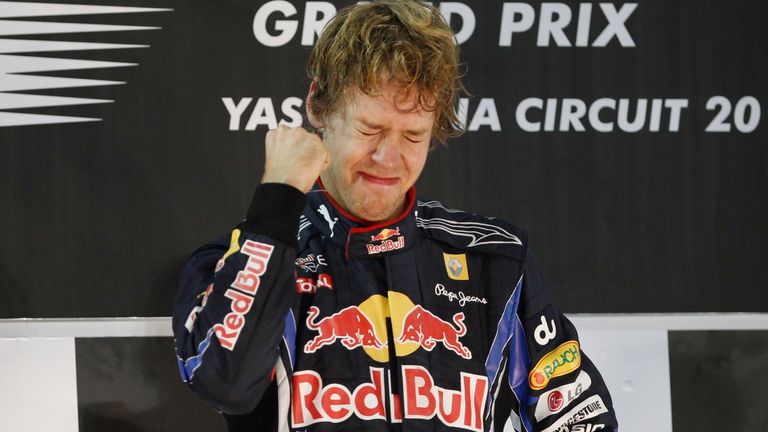 FILE - Red Bull driver Sebastian Vettel of Germany cries on the podium after becoming 2010 Formula One World champion and winning the Emirates Formula One Grand Prix at the Yas Marina racetrack, in Abu Dhabi, United Arab Emirates, Sunday, Nov.14, 2010. Four-time Formula One champion Sebastian Vettel says he will retire at the end of the season to spend more time with his family. The German driver won the F1 title from 2010-13 with the Red Bull team.