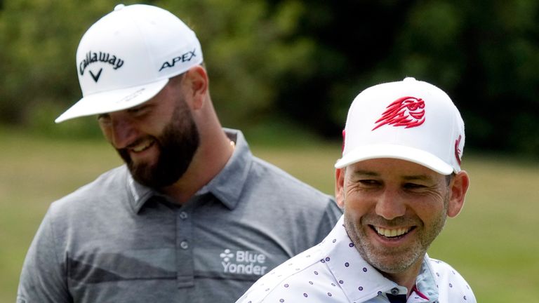Sergio Garcia, right, and Jon Rahm smile on the third green during a practice round of the U.S. Open golf tournament at Los Angeles Country Club, Monday, June 12, 2023, in Los Angeles. (AP Photo/Marcio Jose Sanchez)