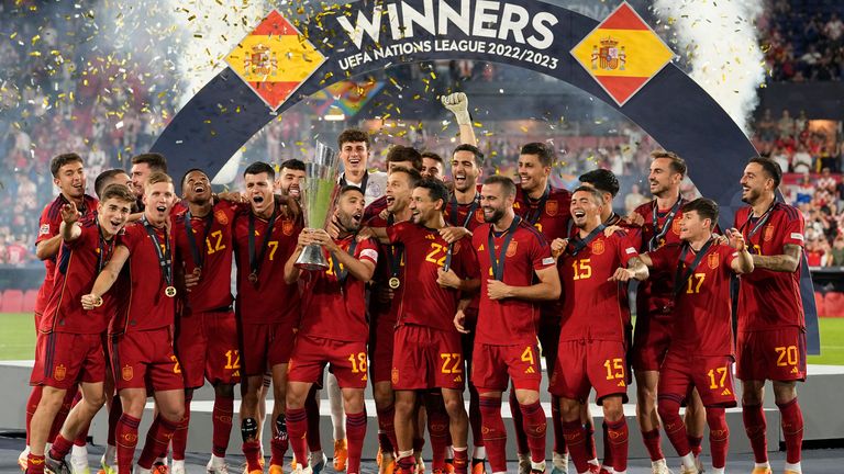 Spain players celebrate with the Nations League trophy