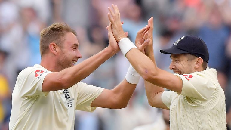 England's Stuart Broad, left, celebrates with teammate James Anderson after taking the wicket of Australia's Shaun Marsh, caught out for 4 runs, during the fifth day of their Ashes cricket test match in Melbourne, Australia, Saturday, Dec. 30, 2017. (AP Photo/Andy Brownbill)