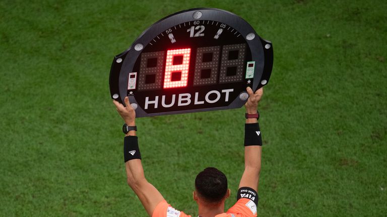LUSAIL CITY, QATAR - DECEMBER 18:  The Assistant Referee holds up the board showing eight minutes of time added on during the FIFA World Cup Qatar 2022 Final match between Argentina and France at Lusail Stadium on December 18, 2022 in Lusail City, Qatar. (Photo by Visionhaus/Getty Images)