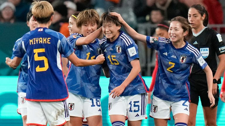 Japan's Aoba Fujino (15) is congratulated by team-mates after scoring