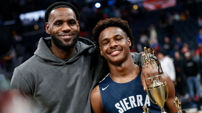 LeBron James, left, poses with his son Bronny after Sierra Canyon beat Akron St. Vincent - St. Mary in a high school basketball game Saturday, Dec. 14, 2019, in Columbus, Ohio. (AP Photo/Jay LaPrete)