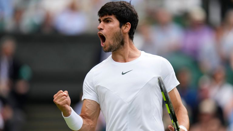 Spain's Carlos Alcaraz reacts as he wins a point against Denmark's Holger Rune in a men's singles match on day ten of the Wimbledon tennis championships in London, Wednesday, July 12, 2023. (AP Photo/Kirsty Wigglesworth)