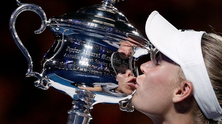 Denmark&#39;s Caroline Wozniacki kisses her trophy after defeating Romania&#39;s Simona Halep in the women&#39;s singles final at the Australian Open 