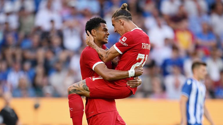 Cody Gakpo of Liverpool celebrates with teammate Kostas Tsimikas of Liverpool after scoring his team's secondgoal during the pre-season friendly match between Karlsruher SC and Liverpool FC at BBBank Wildparkstadion on July 19, 2023 in Karlsruhe, Germany.