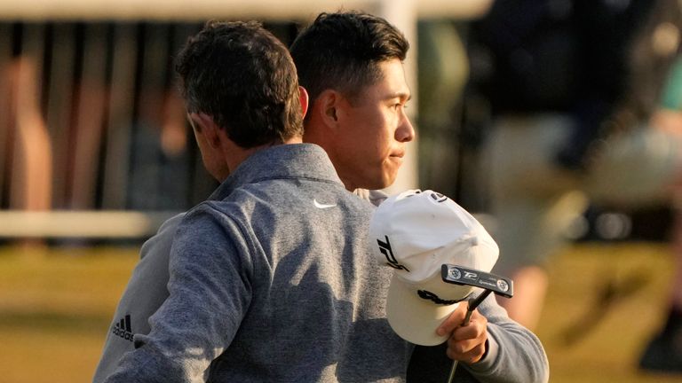 Collin Morikawa of the US, and Northern Ireland's Rory McIlroy, left, greet each other on the 18th green after their second round of the British Open golf championship on the Old Course at St. Andrews, Scotland, Friday July 15, 2022. The Open Championship returns to the home of golf on July 14-17, 2022, to celebrate the 150th edition of the sport's oldest championship, which dates to 1860 and was first played at St. Andrews in 1873. (AP Photo/Gerald Herbert)