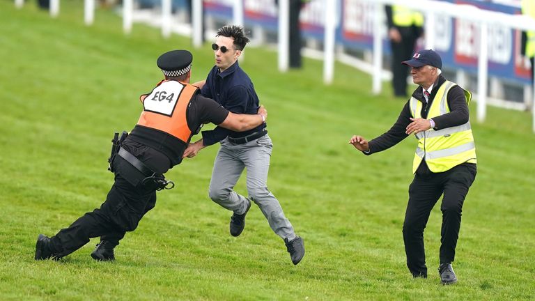Ben Newman, 32, was sentenced to 18 weeks imprisonment suspended for two years after running onto the track at Epsom