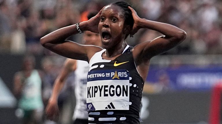 Faith Kipyegon, of Kenya, crosses the finish line to set a new world record