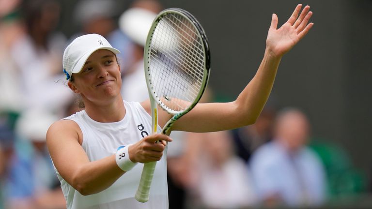 Poland's Iga Swiatek celebrates defeating Spain's Sara Sorribes Tormo during the women's singles match on day three of the Wimbledon tennis championships in London, Wednesday, July 5, 2023. (AP Photo/Alastair Grant)