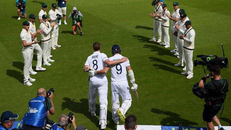 Stuart Broad puts an arm around James Anderson before walking through Australia's guard of honour on day four of the fifth Ashes Test