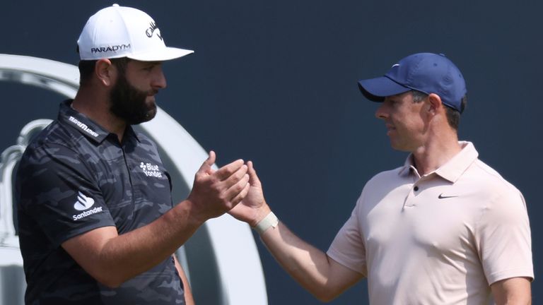 Spain's Jon Rahm, left greets Northern Ireland's Rory McIlroy on the 1st tee before their round on the first day of the British Open Golf Champi onships at the Royal Liverpool Golf Club in Hoylake, England, Thursday, July 20, 2023. (AP Photo/Peter Morrison)