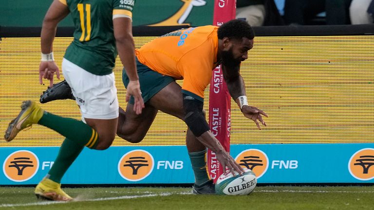 Australia's Marika Koroibete, right, scores a try as South Africa's Kurt-Lee Arendse watches on during the Rugby Championship test match between South Africa and Australia at Loftus Versfeld stadium in Pretoria, South Africa, Saturday, July 8, 2023. (AP Photo/Themba Hadebe)