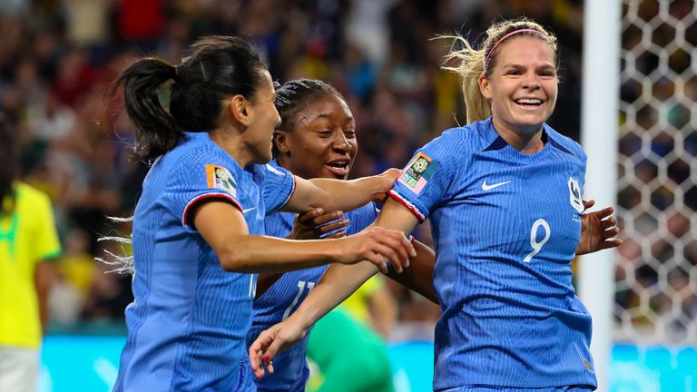 France's Eugenie Le Sommer, right, is congratulated by teammate's Kenza Dali, left, and Kadidiatou Diani after scoring their first goal during the Women's World Cup Group F soccer match between France and Brazil in Brisbane, Australia, Saturday, July 29, 2023. (AP Photo/Tertius Pickard)